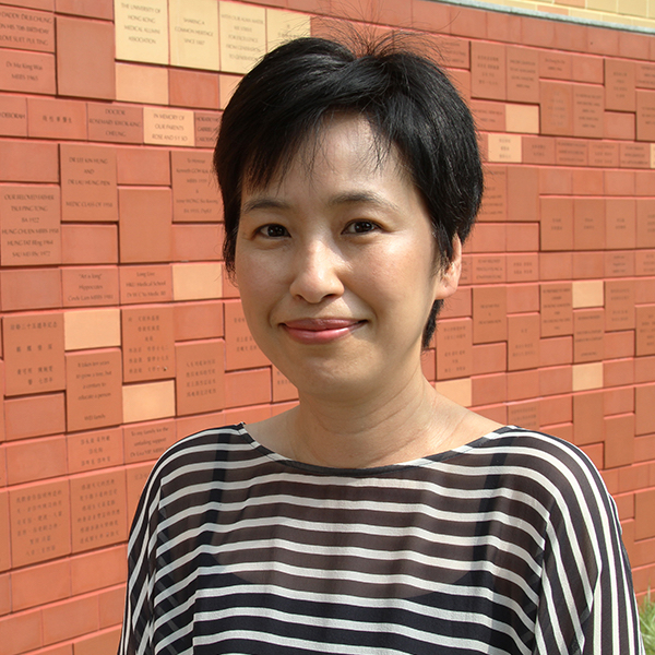 Woman with short hair smiling wearing a stripy top