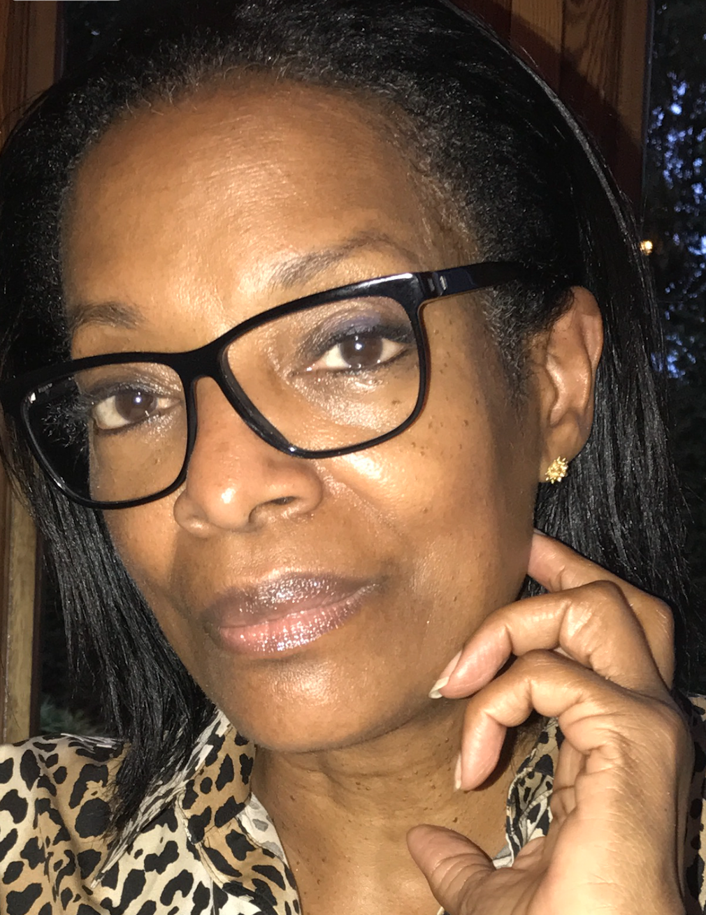 A photo of Patricia Viseur Sellers Esq, wearing black-rimmed glasses.